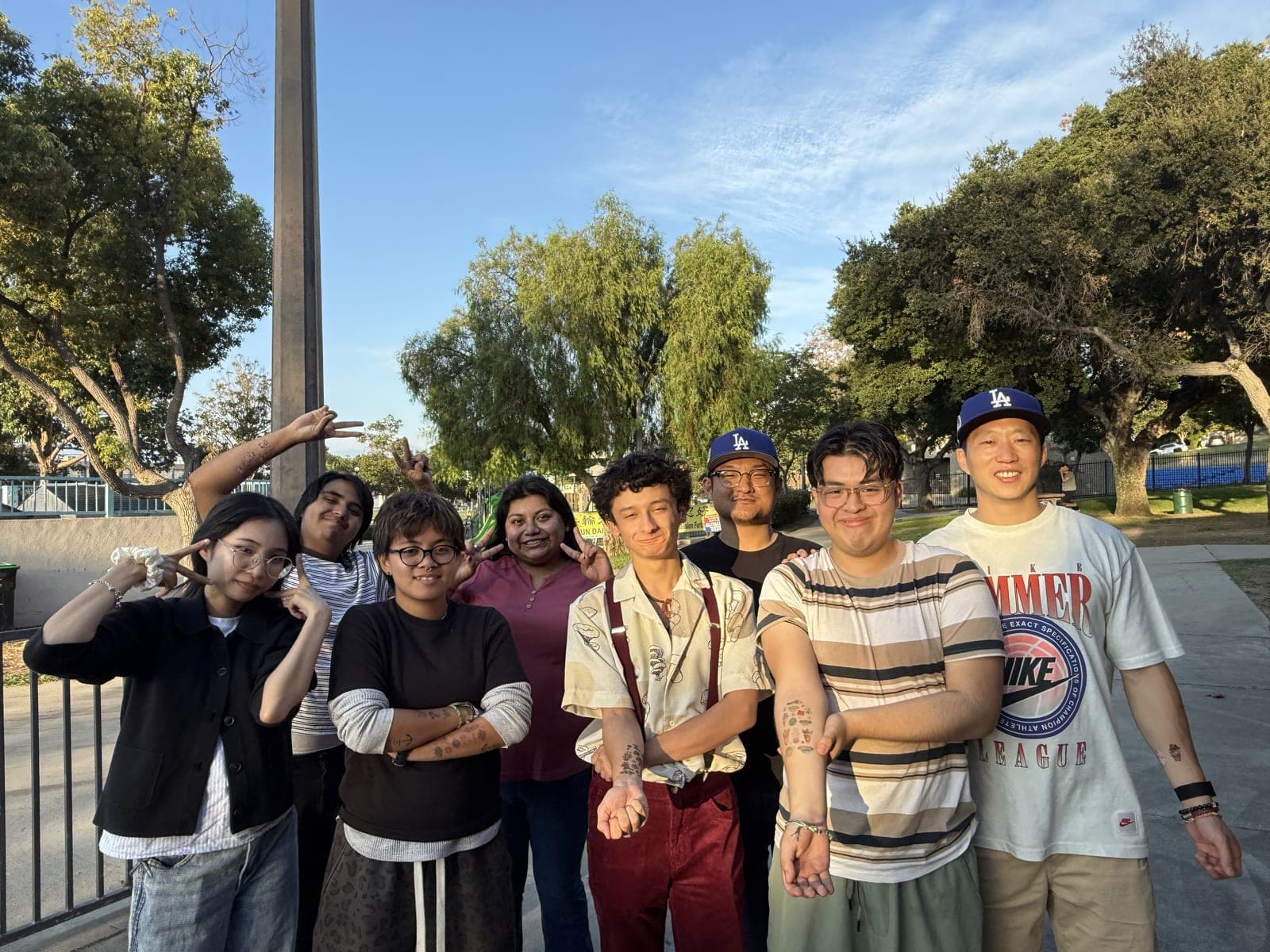 A group of MFC youth and staff posing together outdoors