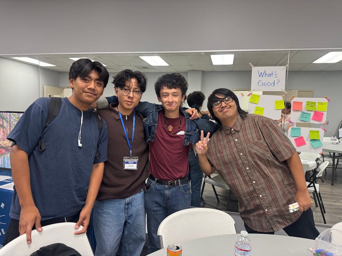 Four MFC youth posing together with their arms around each other at a workshop