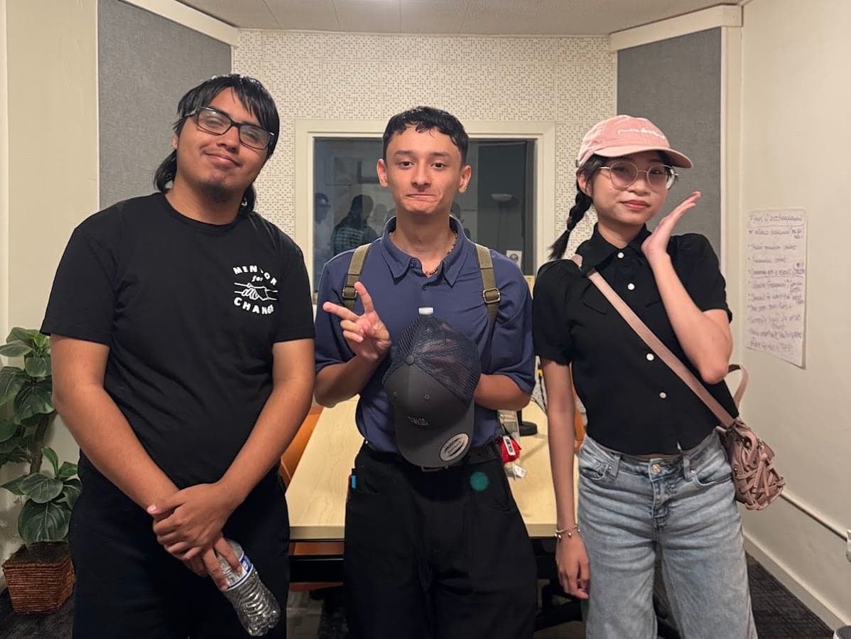 Three MFC interns smiling together in their work clothes
