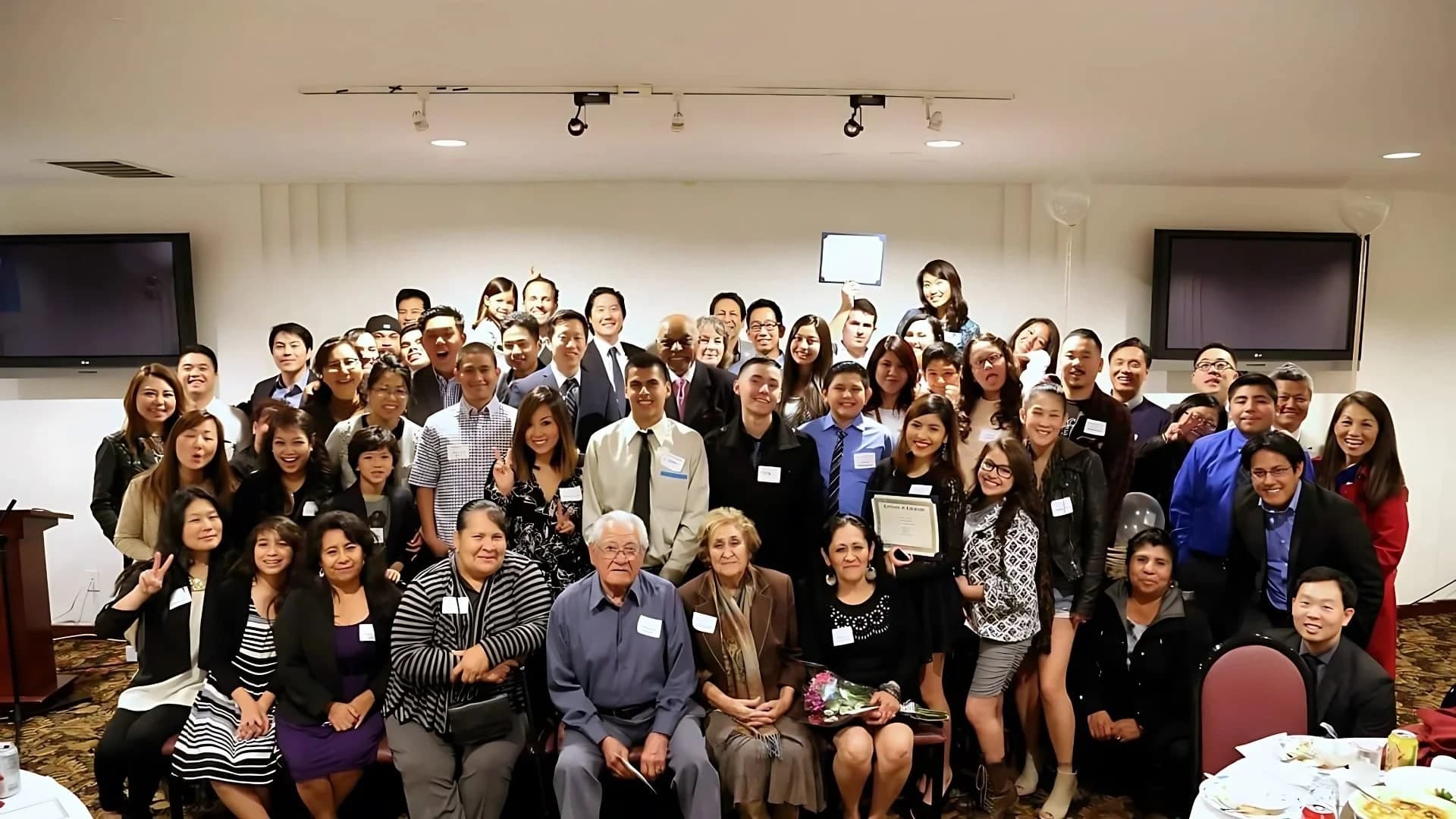 A large group of Mentor For Change mentors, mentees, and families gathered for a celebration