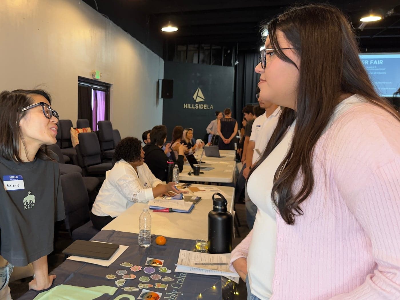 A young person talking with a professional at an MFC career event