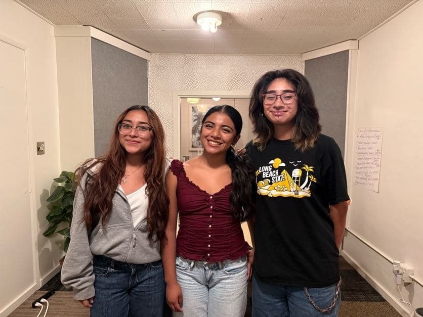 Three young people smiling together