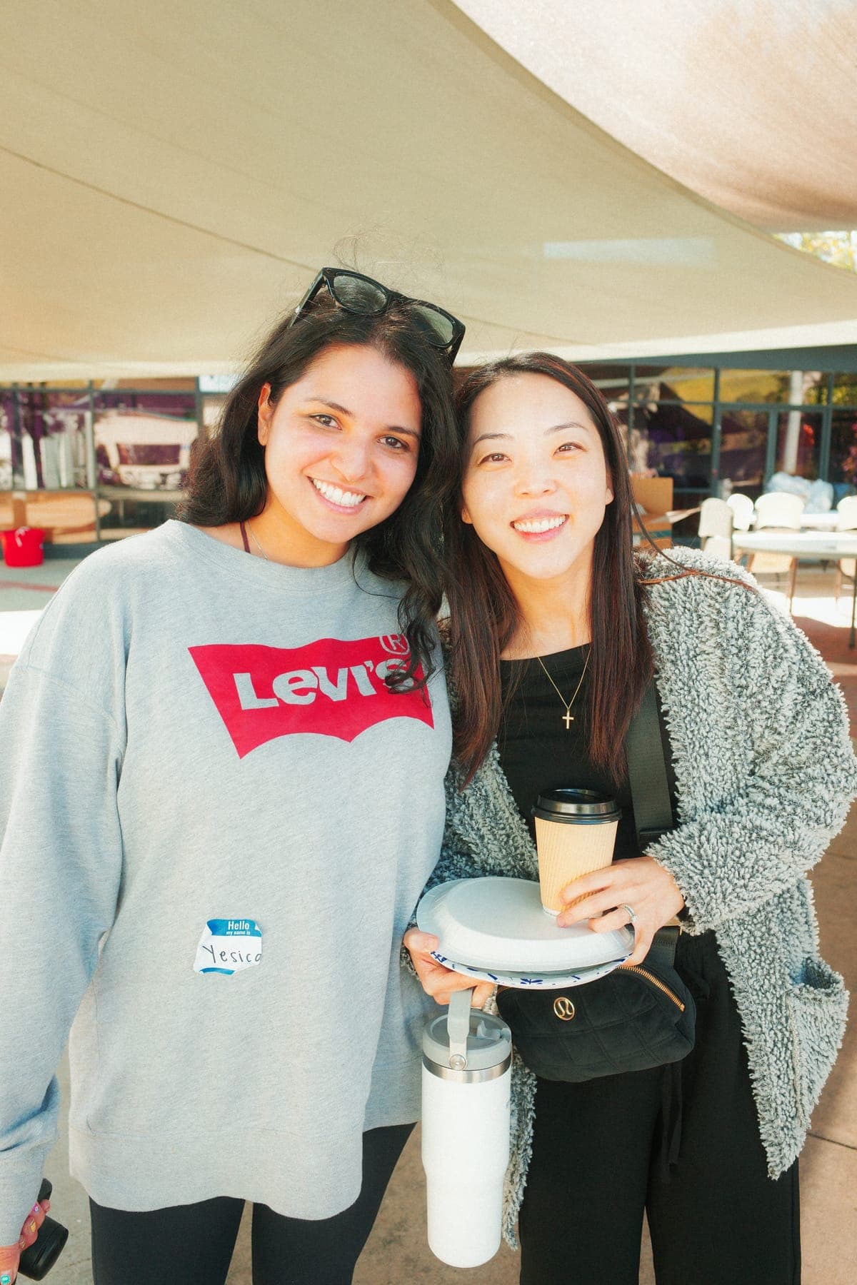 Two MFC volunteers smiling together at an event